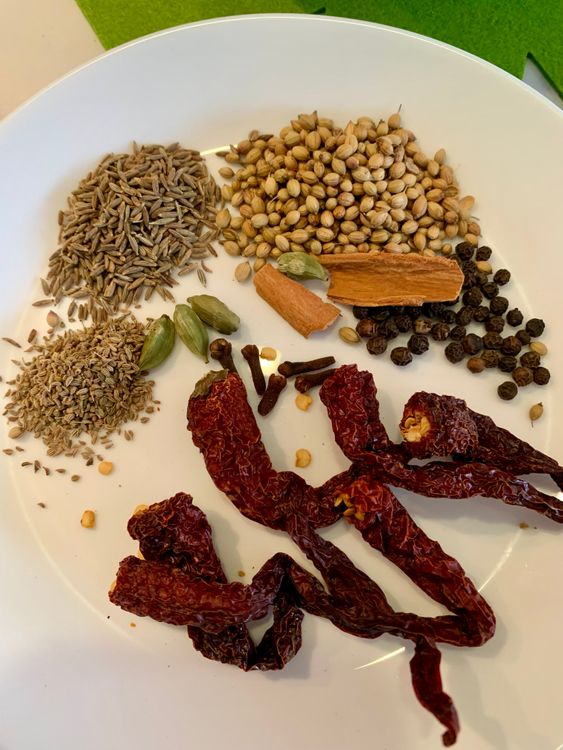 Step 2.1: Dry roast coriander seeds, cumin seeds, peppercorns, ajwain, cinnamon, cardamoms, cloves, and whole red chillies on low-medium heat for 2–3 minutes until aromatic