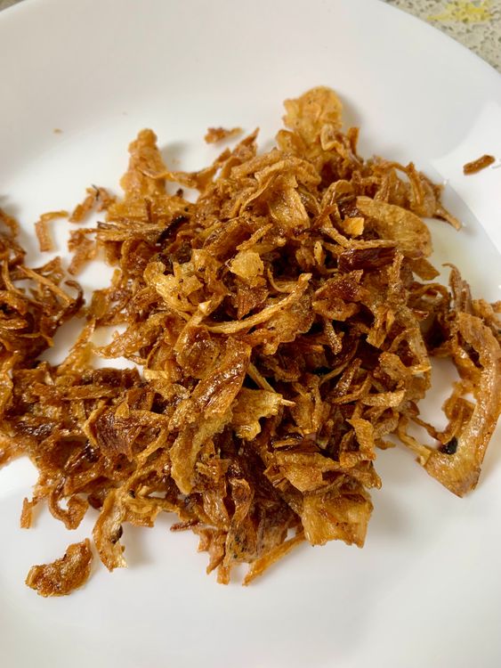 Step 3.2: Heat oil in a flat pan and fry onions until golden