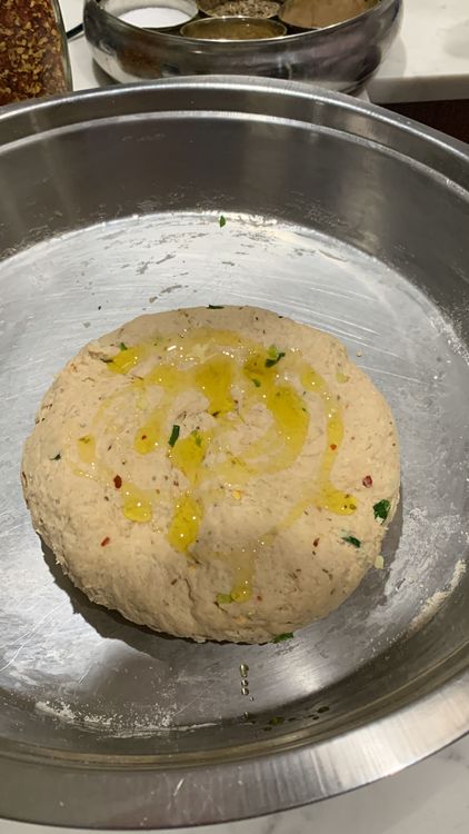 Step 1.1: Once the dough is ready, brush it with a tbsp of oil and gently knead it again for a few seconds