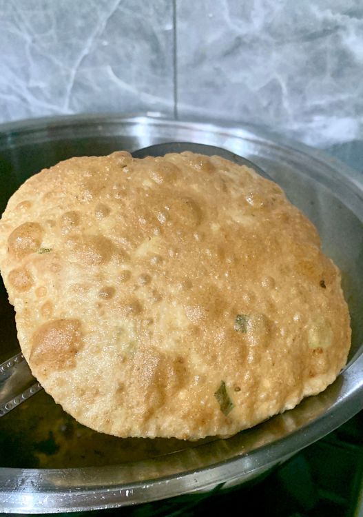 Step 1.1: Remove the puffed poori from the oil using a slotted spoon and place it on the kitchen towel to absorb any excess oil