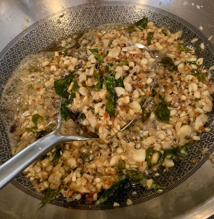 Step 2.1: Add the chopped garlic, ginger, green chillies, and curry leaves to the pan