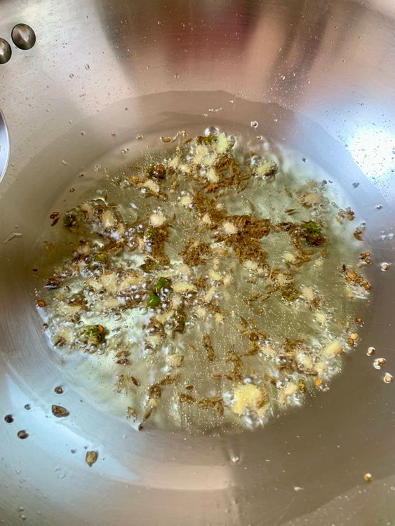 Step 1.1: Add chopped ginger and green chillies; sauté until fragrant and lightly golden