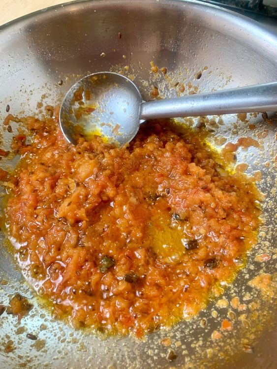 Step 1.1: Add tomatoes and cook until they soften and the masala starts releasing oil