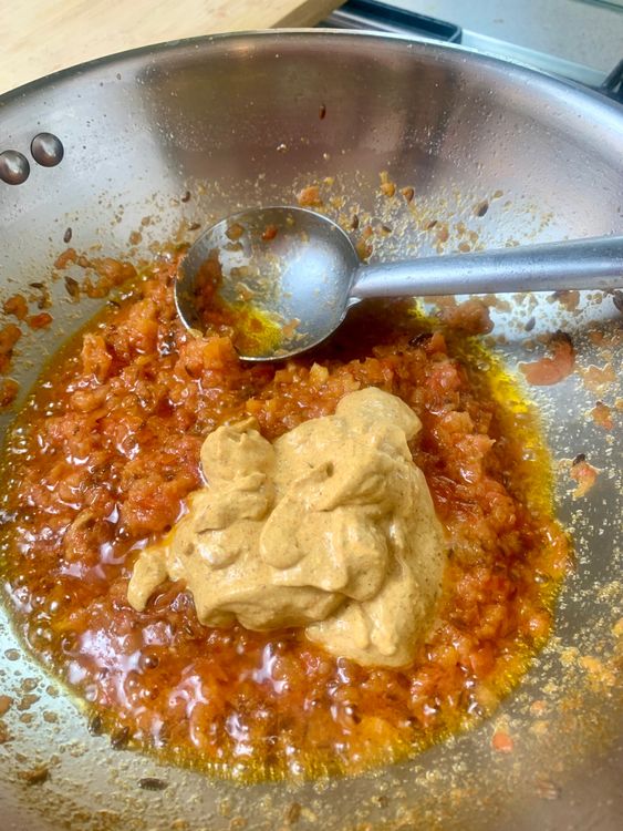 Step 1.1: Lower the flame and add the curd mixture along with ½ cup of water