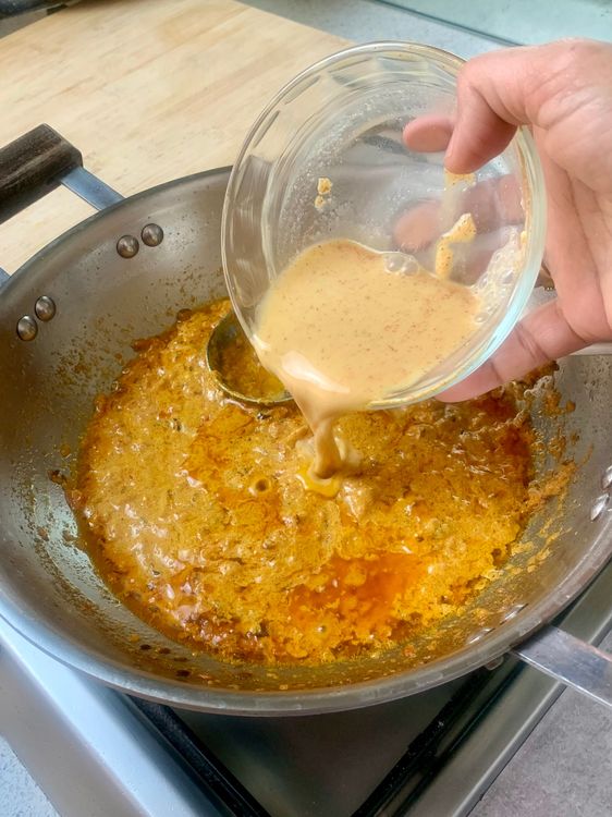 Step 1.2: Lower the flame and add the curd mixture along with ½ cup of water