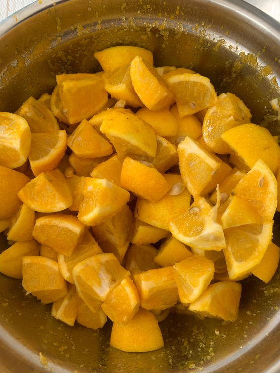 Step 1.1: In a mixing bowl, combine lemon pieces with salt and turmeric powder