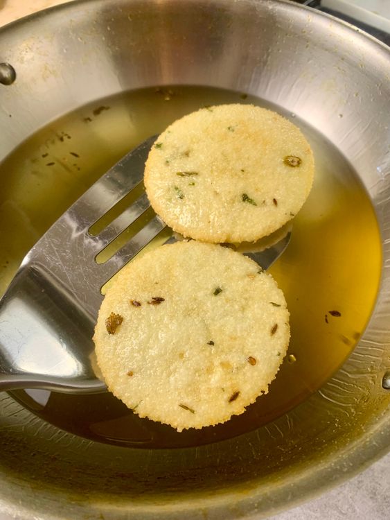 Step 3.1: Gently slide the poori into the hot oil