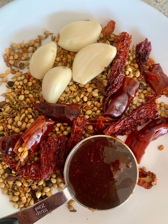 Step 2.1: Grind the roasted spices with garlic and tamarind pulp to form a paste, adding very little water