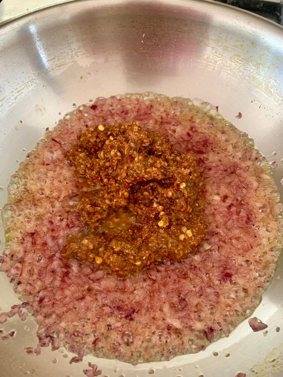Step 3.1: Add the masala paste and masala rinse water and cook until the ghee separates