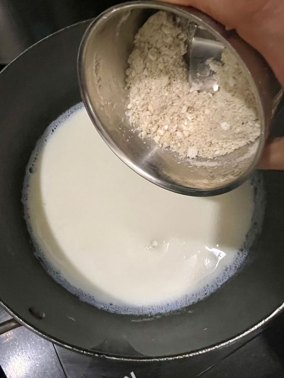 Step 1.1: Add the ground foxnuts and cashew paste to boiling milk