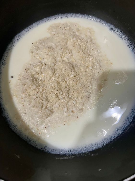 Step 1.2: Add the ground foxnuts and cashew paste to boiling milk