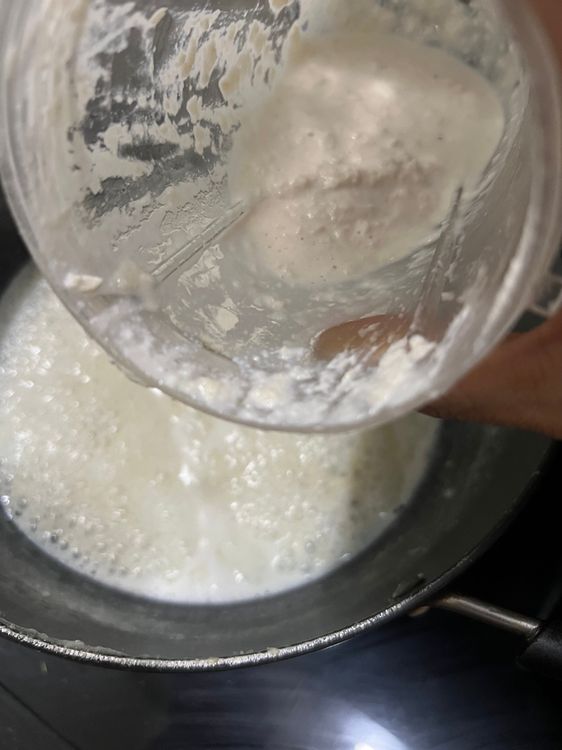 Step 1.3: Add the ground foxnuts and cashew paste to boiling milk