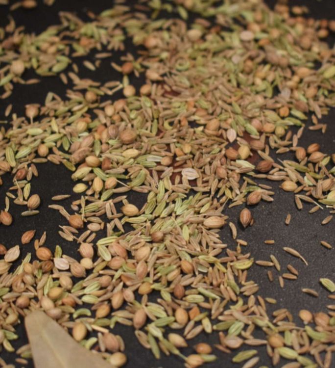 Step 1.2: Dry roast coriander seeds, fennel seeds, cumin seeds, bay leaves, dry red chillies, black pepper corns, and cloves on low flame for 5-7 minutes