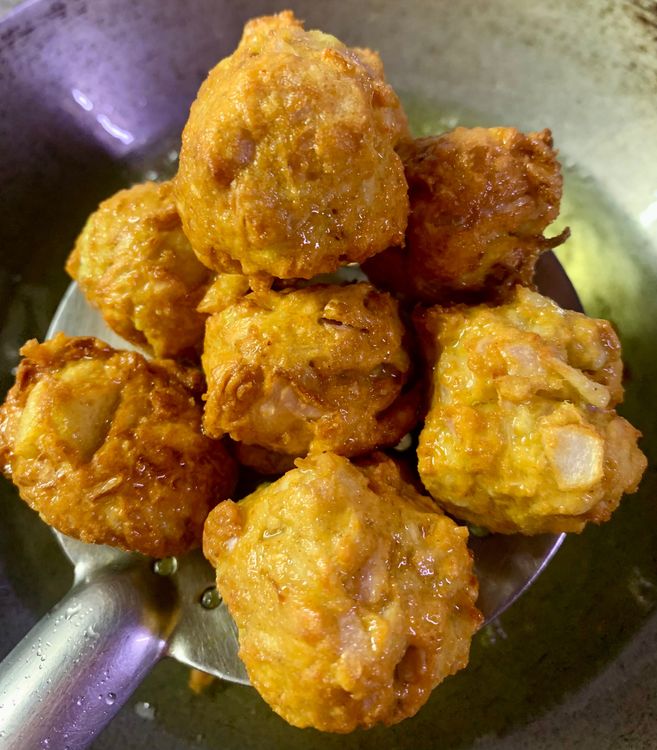Step 2.2: Carefully place the balls into the oil and let them fry for a minute