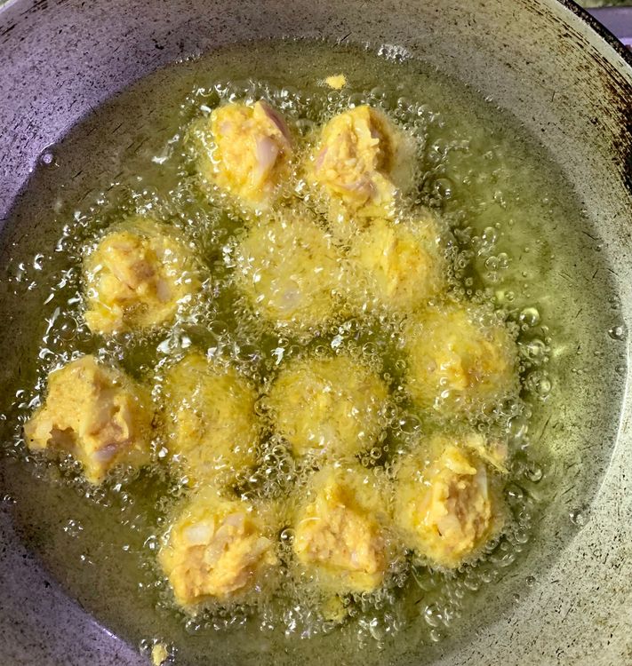 Step 2.1: Carefully place the balls into the oil and let them fry for a minute