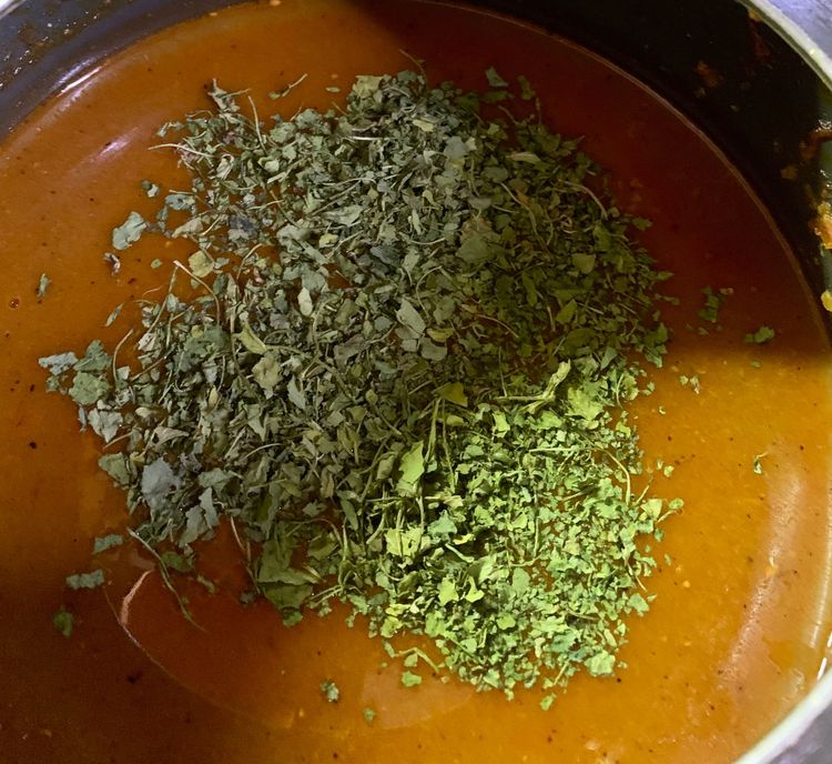 Step 1.1: Now add the remaining cooked water of the boiled beans to the cooker along with 1 cup water and add kasuri methi and bring to a boil
