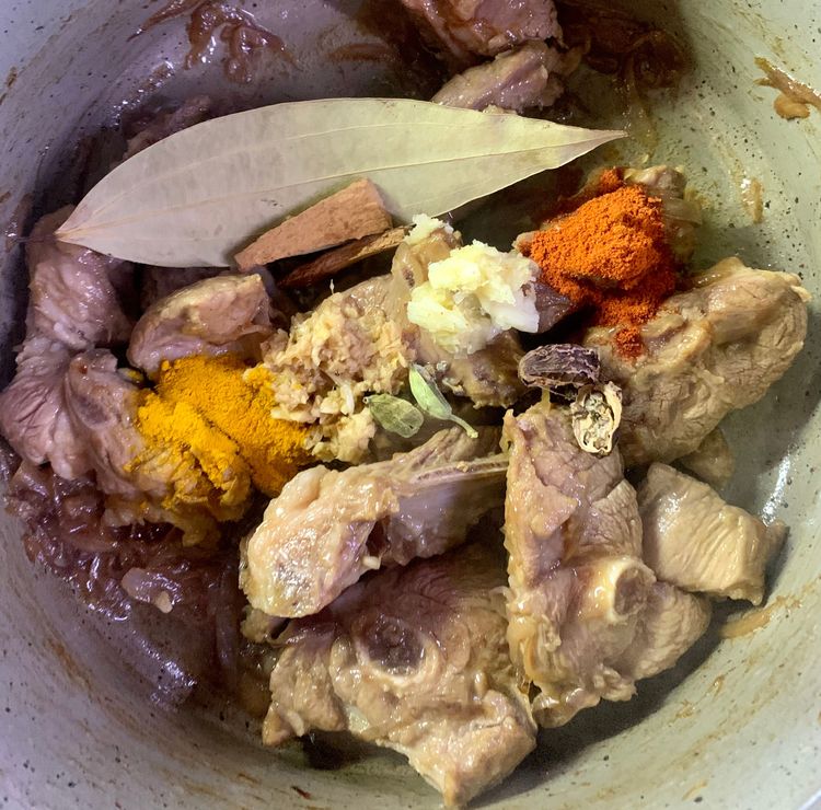 Step 1.1: Add ginger, crushed garlic (half tsp), turmeric, red chilli powder, green cardamoms, black cardamom, cinnamon sticks and bay leaf