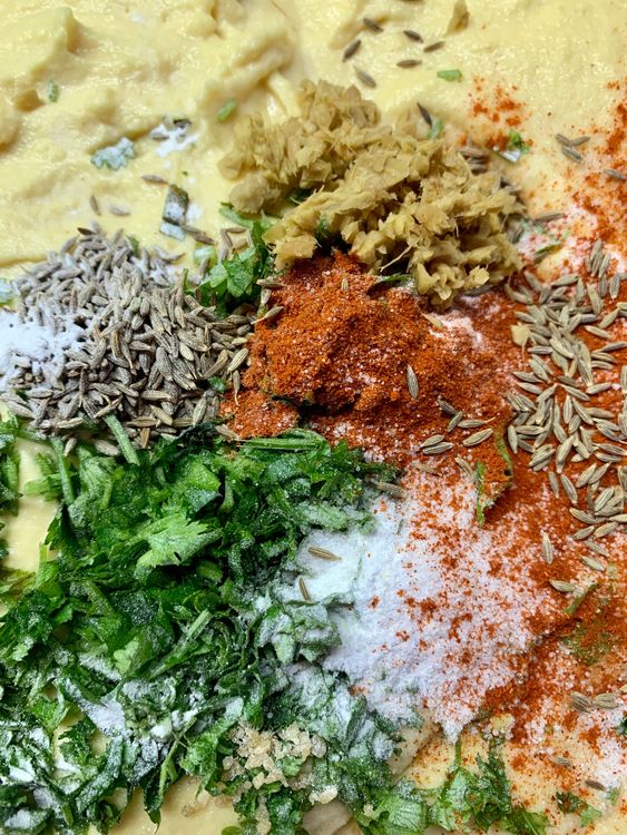 Step 1.1: Add ginger, cumin seeds, red chilli powder, chopped coriander leaves and salt to the batter