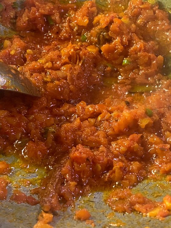 Step 3.1: Add the tomatoes and chopped green chilli, stir and cook for 3-4 minutes until soft and the oil starts to ooze out