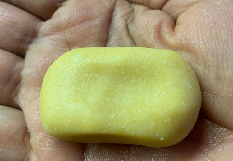 Step 1.1: Take a small portion of the mixture, make a round/rectangle shape and slightly flatten it on your palm, and press lightly in the center with your finger