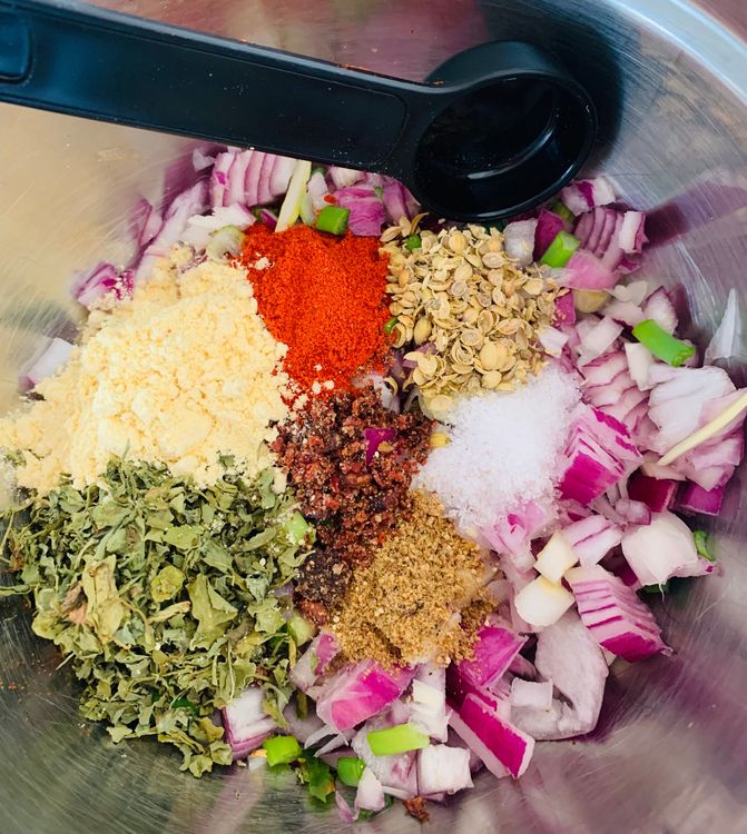 Step 2.1: Add roasted gram flour, salt, red chilli powder, coriander powder, carom seeds, pomegranate seeds and fenugreek leaves