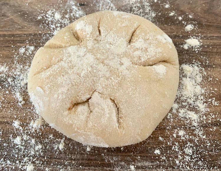 Step 2.3: Place a portion of prepared stuffing and seal all sides of the dough together to form a ball