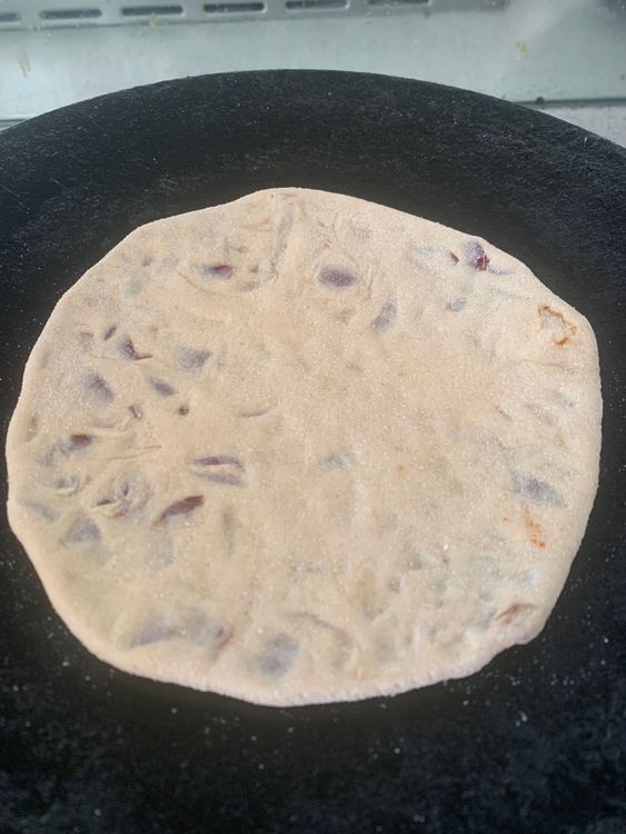 Step 2.1: Apply a little oil with a cooking brush on the hot tawa and flip the stuffed paratha on it