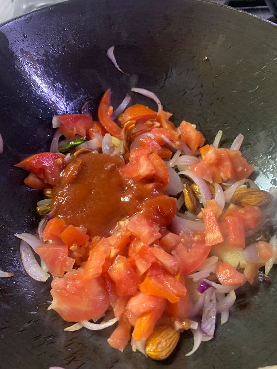 Step 2.1: Add chopped tomatoes and tomato puree, mix nicely, and saute for 2-3 minutes