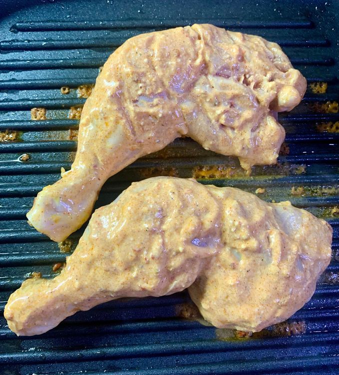 Step 1.1: Reduce the heat from low to medium and gently place the marinated chicken and press down gently to help them make contact with the pan