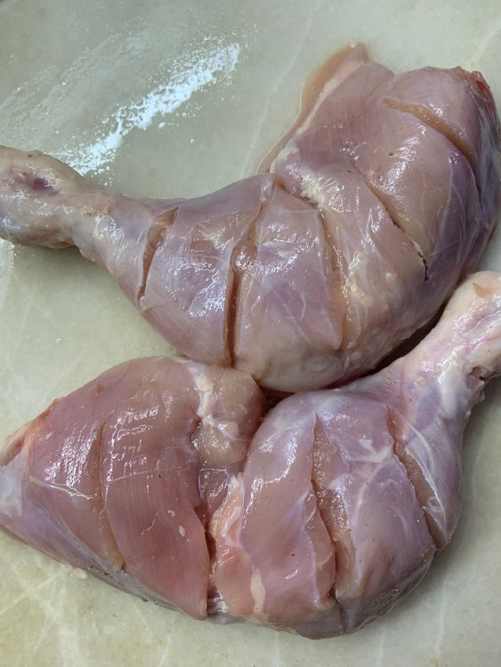 Step 1.1: Use a sharp knife to make 4-5 slits on the chicken's whole legs