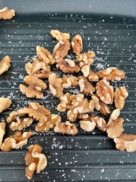 Step 2.1: Add walnuts and salt and dry roast for 8-10 minutes
