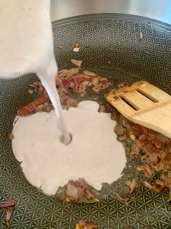 Step 3.1: Add the prepared walnut paste while continuously stirring so that the paste does not stick to the bottom of the pan