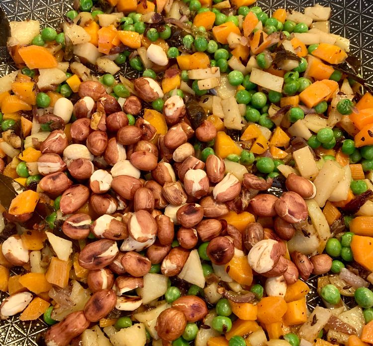 Step 2.1: Add the roasted peanuts and stir for a minute