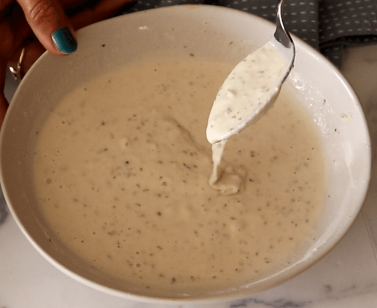 Step 2.1: Gradually add water while stirring to form a thick, smooth batter that can coat the paneer evenly