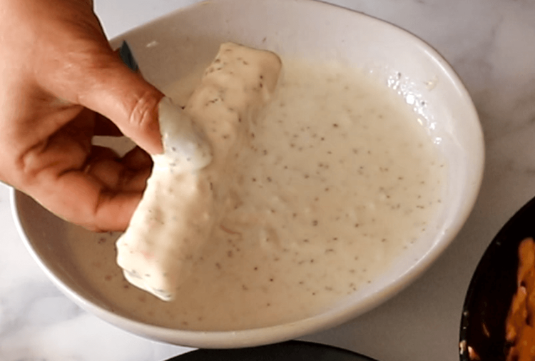 Step 3.1: Dip the marinated paneer pieces into the batter, coating it well