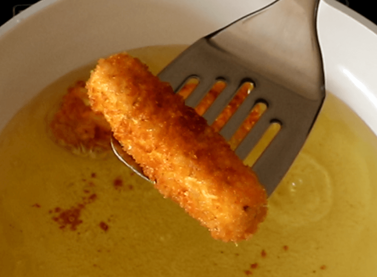 Step 4.1: Turn them gently once they firm up, frying until golden and crispy