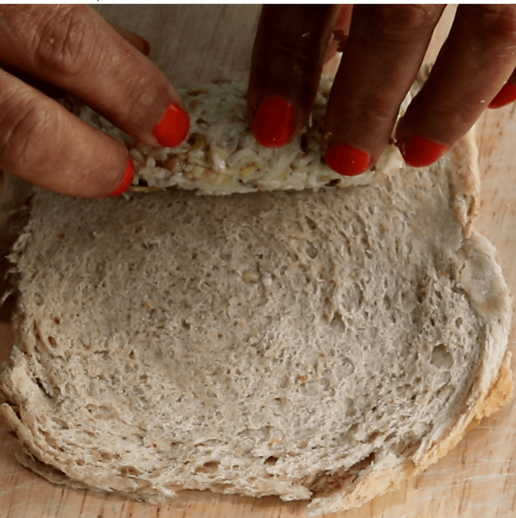 Step 3.1: Place one portion of the coconut-nut filling at one end of a flattened bread slice