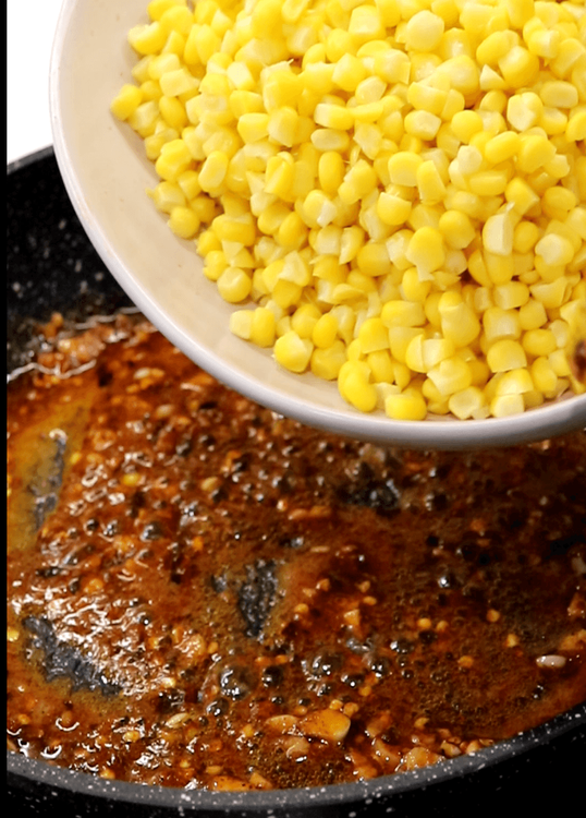 Step 3.1: Add the cooked corn kernels and stir well to coat the corn evenly with the spiced butter