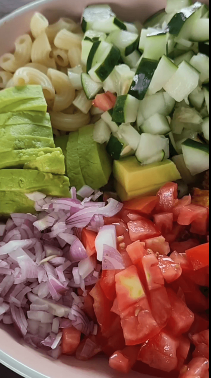 Step 3.2: In a large bowl, combine the cooked pasta, diced cucumber, diced red onion, diced tomato, and sliced chicken (or beans, if vegan/vegetarian)