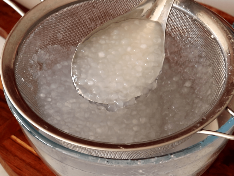 Step 1.1: Strain the cooked sago pearls using a sieve and rinse under cold water