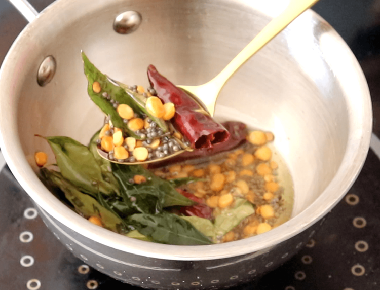 Step 3.1: Toss in the broken red chillies and curry leaves; sauté for a few seconds until aromatic