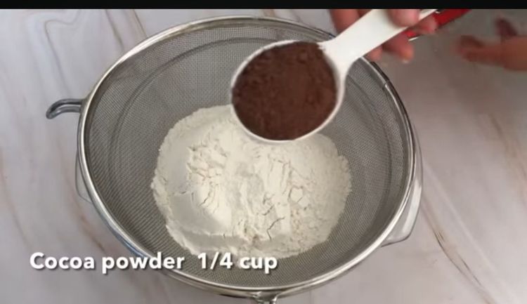 Step 1.2: In a large mixing bowl, combine cocoa powder and milk