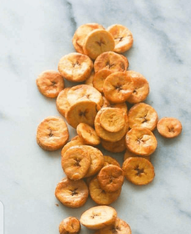 Step 1.1: Pour some oil into a frying pan, allow it to heat, and gently add the sliced plantains into the hot oil