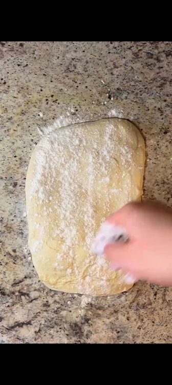Step 1.1: Dust some flour on a clean surface and roll out the pizza dough