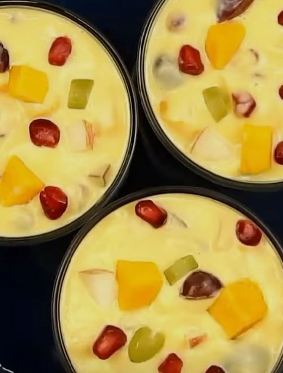 Step 2.2: In individual bowls, add the chopped fruits and pour the cooled custard over them