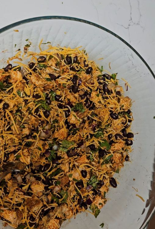 Step 1.1: In a bowl, combine the black beans, red onion, garlic, cilantro, shredded cheddar cheese, taco seasoning, and pre-cooked chicken breast