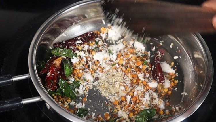 Step 1.4: Add curry leaves and grated coconut