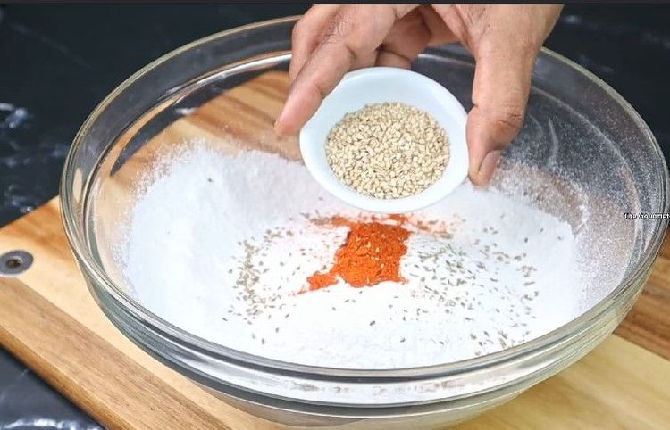Step 2.5: In a mixing bowl, combine rice flour, mashed urad dal, butter or hot oil, carrom seeds, asafoetida, chili powder, and salt