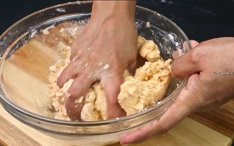 Step 2.2: Gradually add water and knead to form a soft but firm dough