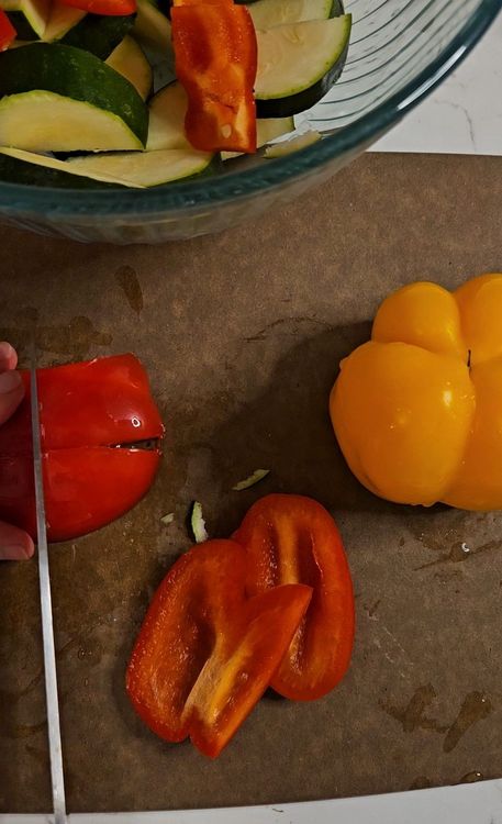 Step 1.1: Cut the red onion, bell peppers, and zucchini into bite-sized pieces